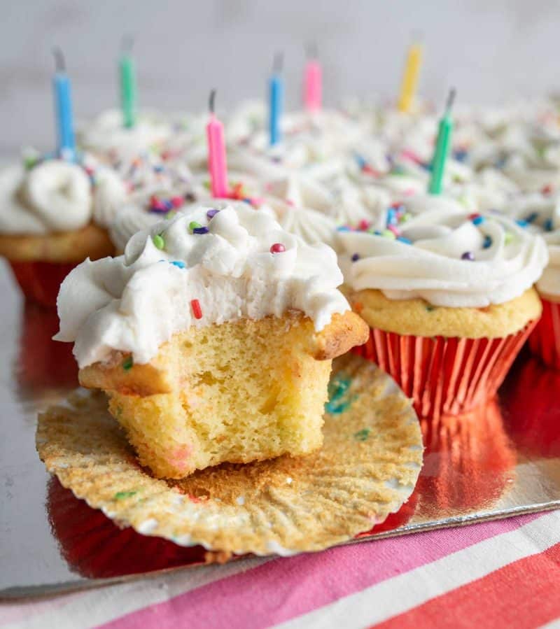 Birthday cupcake shown with a bite taken.