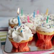 birthday cupcakes with candles lit