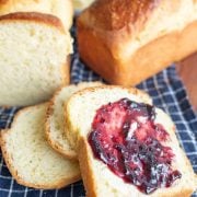 golden brioche bread loafs sliced and buttered with jam
