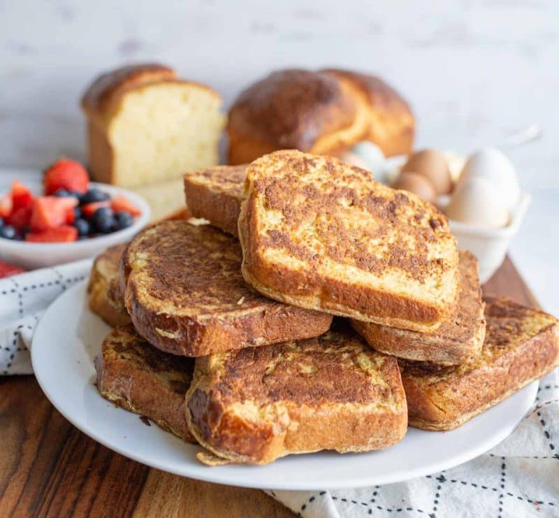 a stack of brioche french toast on a white plate