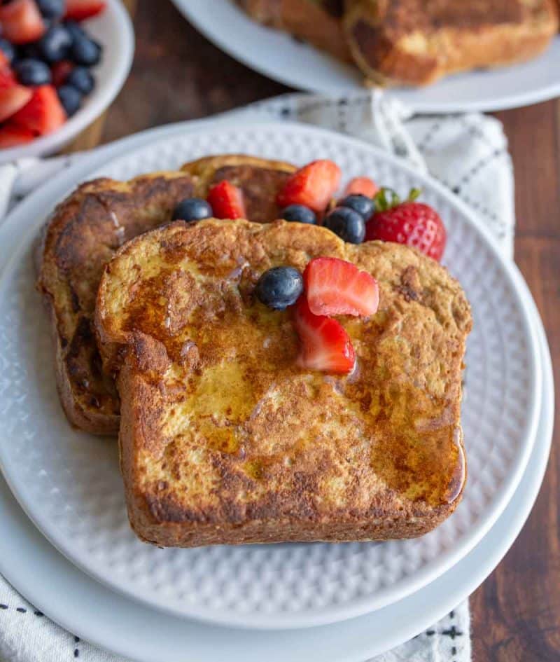 berries and syrup over thick cut brioche french toast