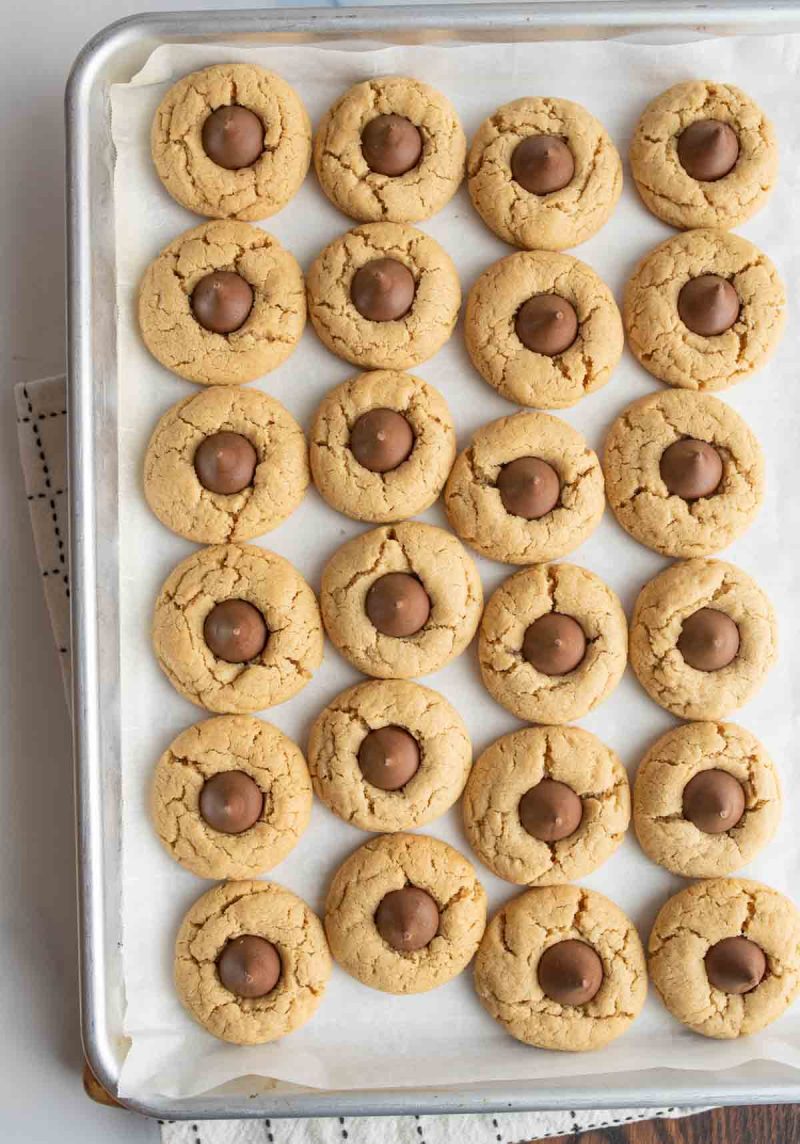 Top view of lots of hershey kiss cookies on a sheet pan.