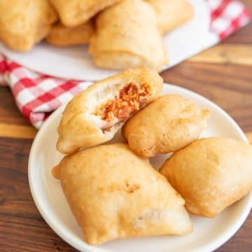 Finished pizza rolls on a white plate