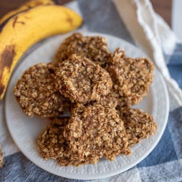 banana oatmeal cookies stacked on a white plate