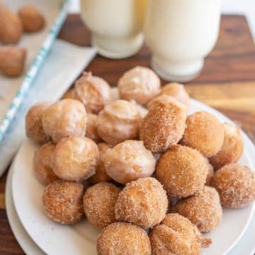donut holes piled on a white plate
