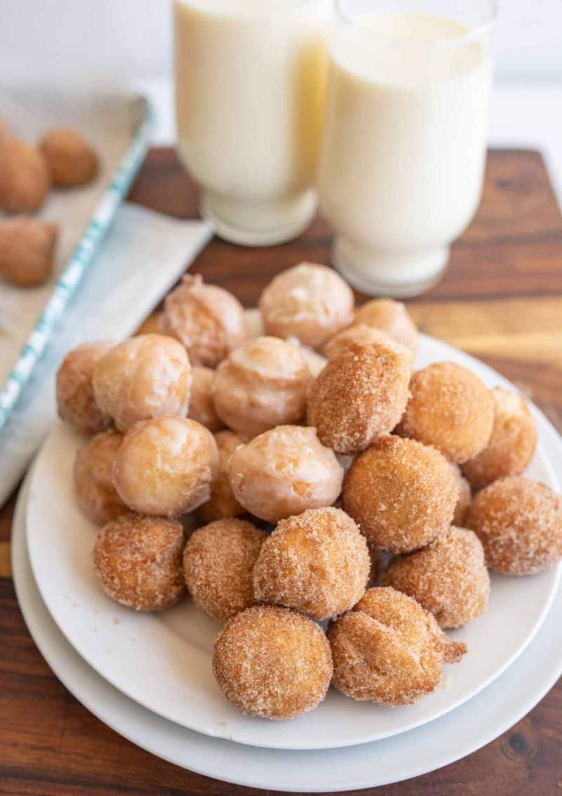 donut holes piled on a white plate