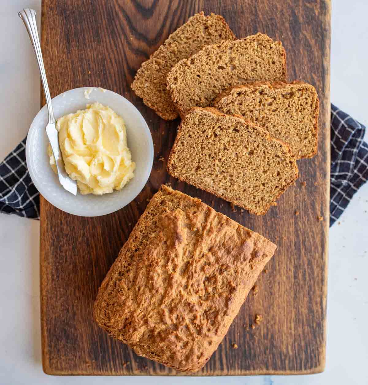 soda bread loaf sliced next to a bowl of butter